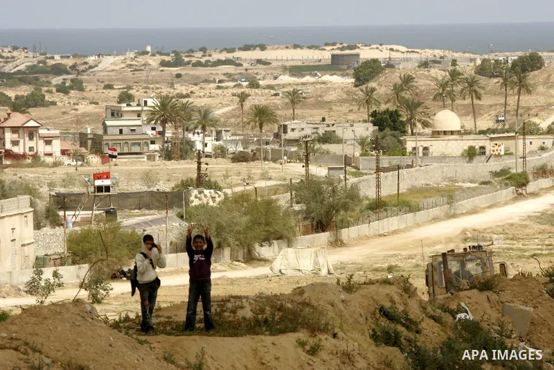 Palestinian boys walk near Rafah close to the border between Egypt and the southern Gaza Strip on April 30, 2011, a day after Egypt said it will permanently open the Rafah border crossing as part of its plans to ease the...