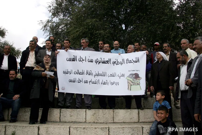 Palestinians residents of Jerusalem demonstrate at the Damascus Gate outside Jerusalem's old city on May 1, 2011, as they welcome reports that rival political movements the secularist Fatah and radical Islamist Hamas fac...