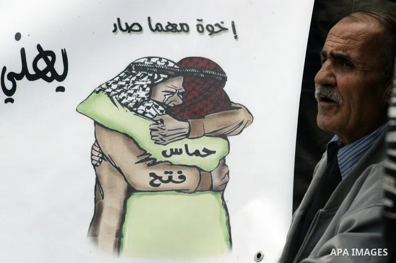 Palestinians residents of Jerusalem demonstrate at the Damascus Gate outside Jerusalem's old city on May 1, 2011, as they welcome reports that rival political movements the secularist Fatah and radical Islamist Hamas fac...
