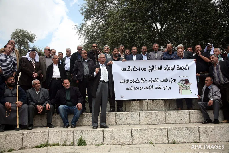 Palestinians residents of Jerusalem demonstrate at the Damascus Gate outside Jerusalem's old city on May 1, 2011, as they welcome reports that rival political movements the secularist Fatah and radical Islamist Hamas fac...