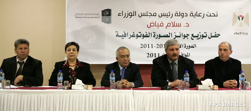 Palestinian prime minister Salam Fayyad attends a celebration to honor the photojournalists who won in the contest of "Palestine for Photography" at the Red Crescent hall in the West Bank city of Ramallah on May 2,2011....