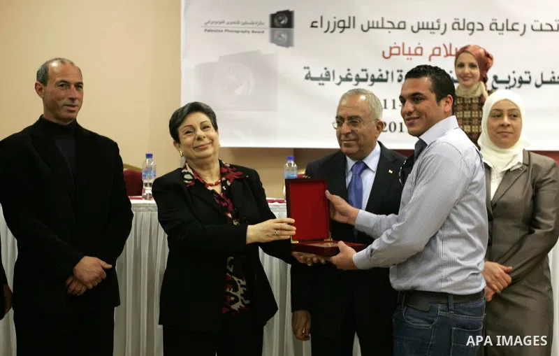 Palestinian prime minister Salam Fayyad honors APAimages photographer, Issam Rimawi during a celebration to honor the journalists who won in the contest of "Palestine for Photography" at the Red Crescent hall in the West...