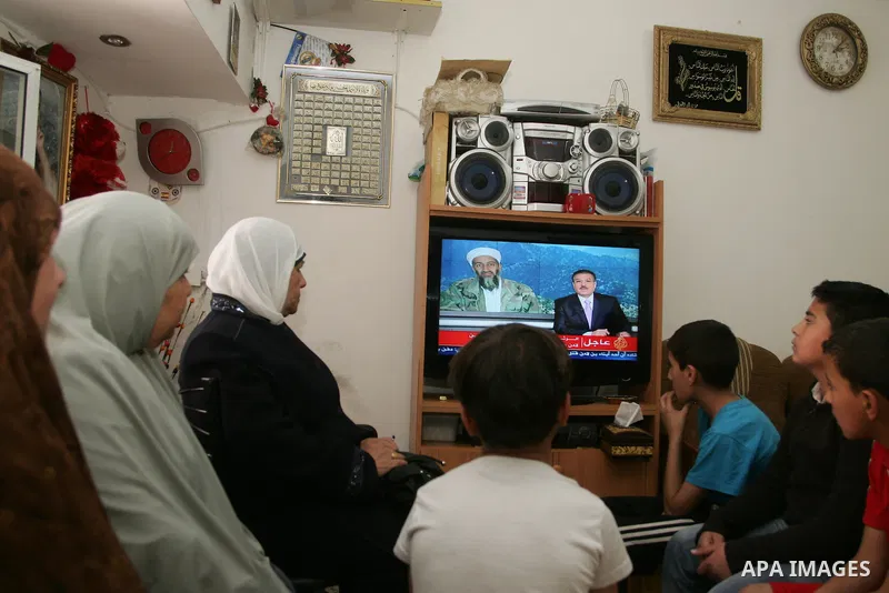 Members of Palestinian family watch a cable TV news report about the killing of Osama bin Laden, at their home in Jerusalem's old city on May 2, 2011. The United States has killed Al-Qaeda leader Osama bin Laden nearly 1...