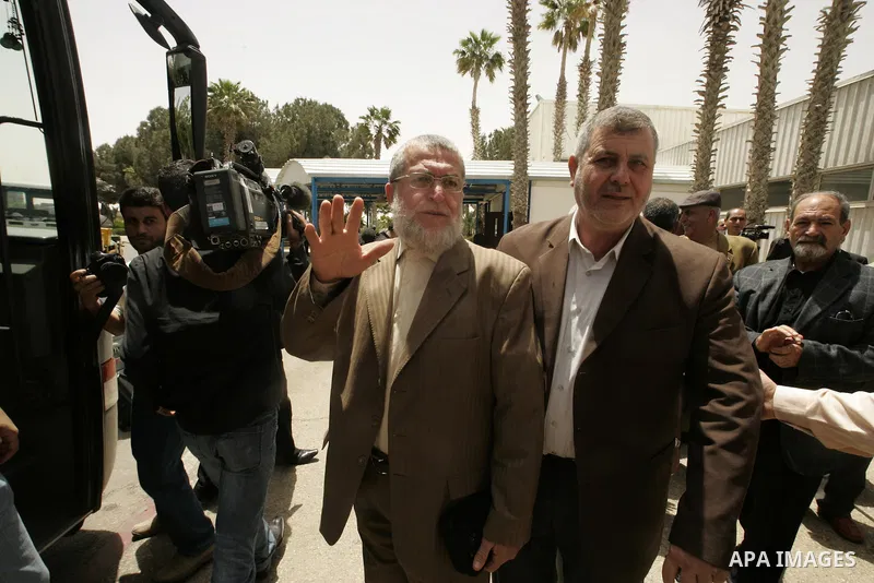 Palestinian Islamic Jihad members Khalid al-Batch and Nafiz Azzam speak as they arrive at the Rafah border terminal in the southern Gaza Strip on May 02, 2011 before crossing to Egypt, as Palestinian factions will ink a...