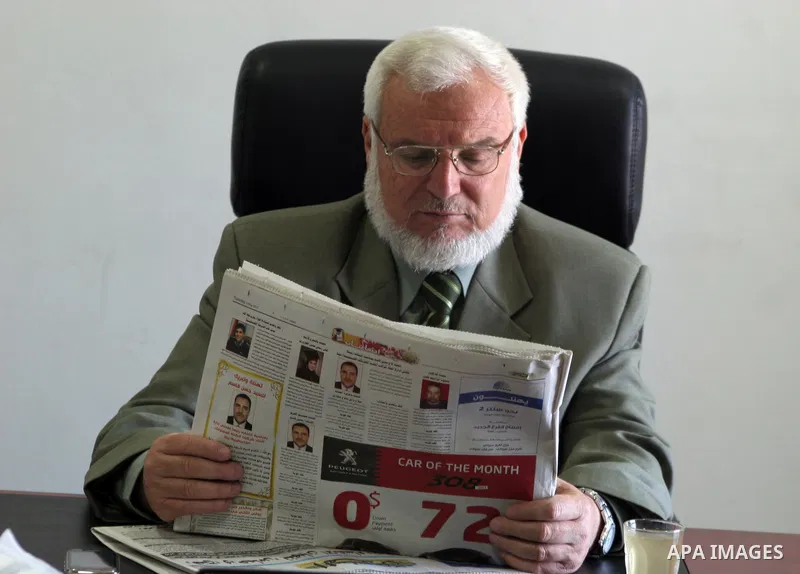 Palestinian parliament spokesman, Aziz Dweik reads a newspaper at his office in the West Bank city of Hebron on May 03, 2011, a day before Palestinian factions sign a reconciliation deal in Cairo intended to repair ties...