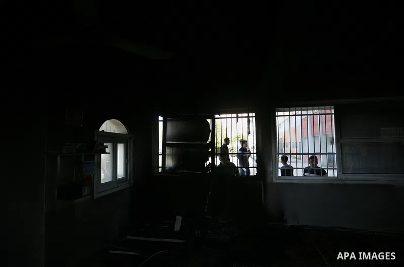 Palestinians inspect a mosque, situated inside a school, which was allegedly burnt by Israeli settlers in the West Bank village of Hawara, south of Nablus, on May 03, 2011 as Israeli police arrested a group of Israeli ci...