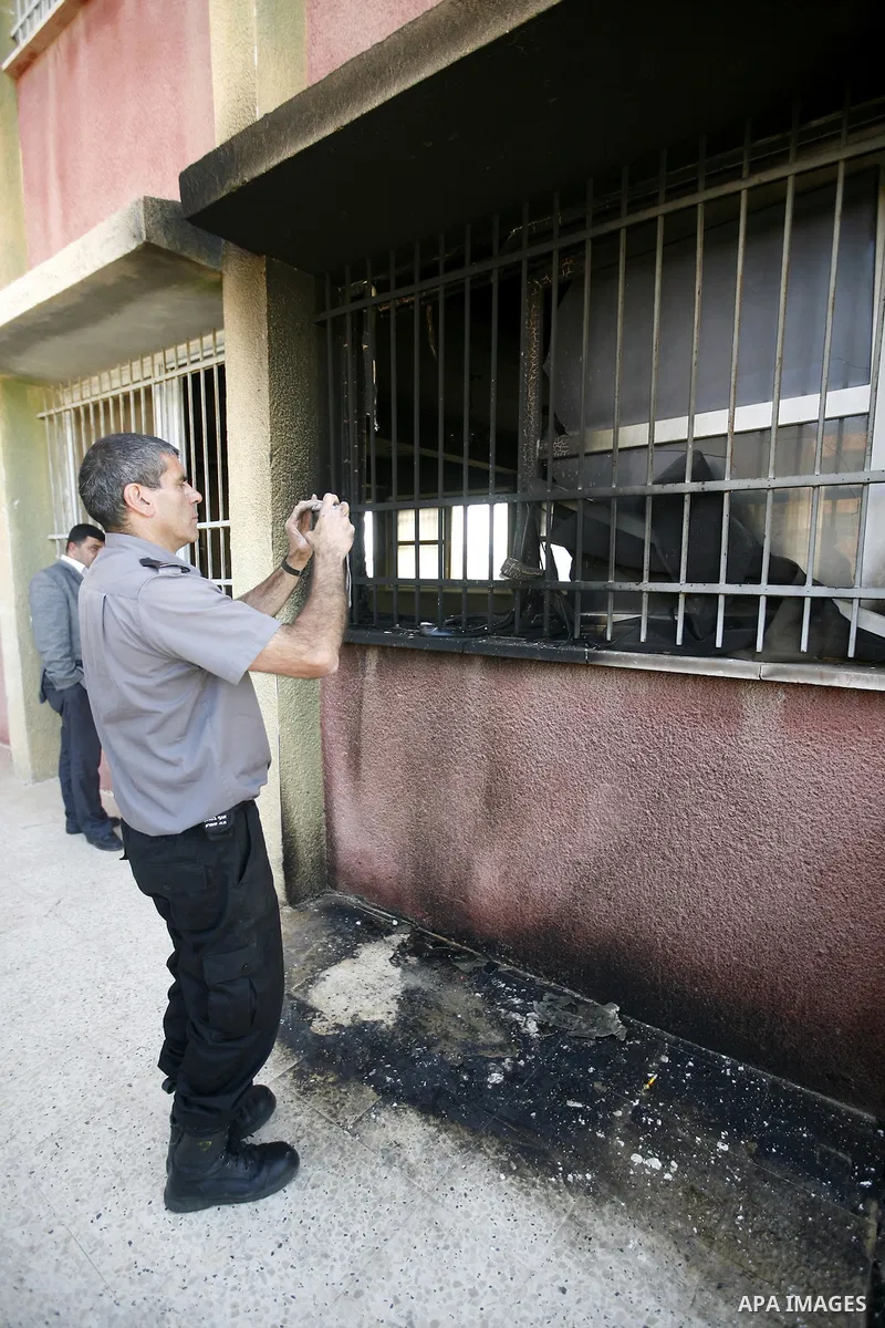 Israeli border guards inspect a mosque, situated inside a school, which was allegedly burnt by Israeli settlers in the West Bank village of Hawara, south of Nablus, on May 03, 2011 as Israeli police arrested a group of I...