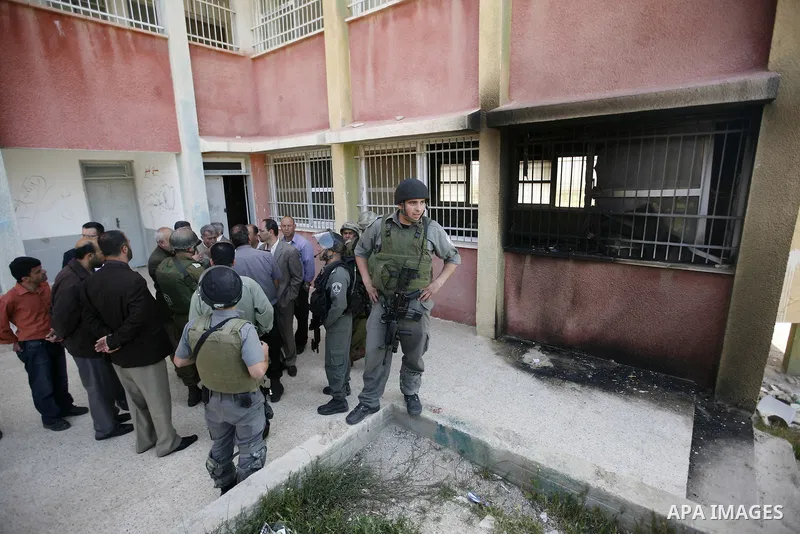Israeli border guards inspect a mosque, situated inside a school, which was allegedly burnt by Israeli settlers in the West Bank village of Hawara, south of Nablus, on May 03, 2011 as Israeli police arrested a group of I...