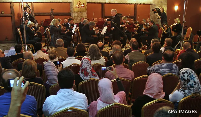 Israeli Maestro Daniel Barenboim, top right, UN Messenger of Peace, conducts the Orchestra for Gaza, a mixed orchestra of European musicians, during concert at the Al Mathaf Cultural House in Gaza City, Tuesday, May, 3,...