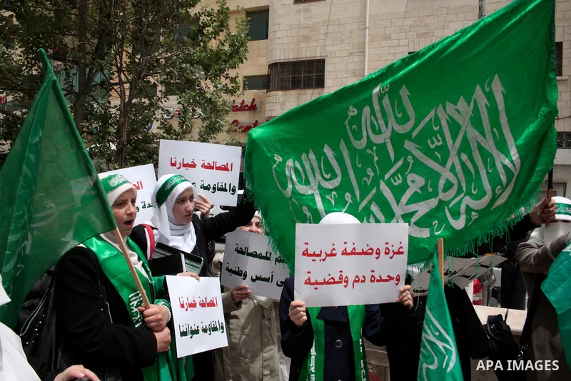 Palestinian women supporters of the Hamas Islamist movement demonstrate in the West Bank city of Hebron on May 04, 2011 as Palestinians in the West Bank and Gaza Strip gather to celebrate and welcome a reconciliation dea...