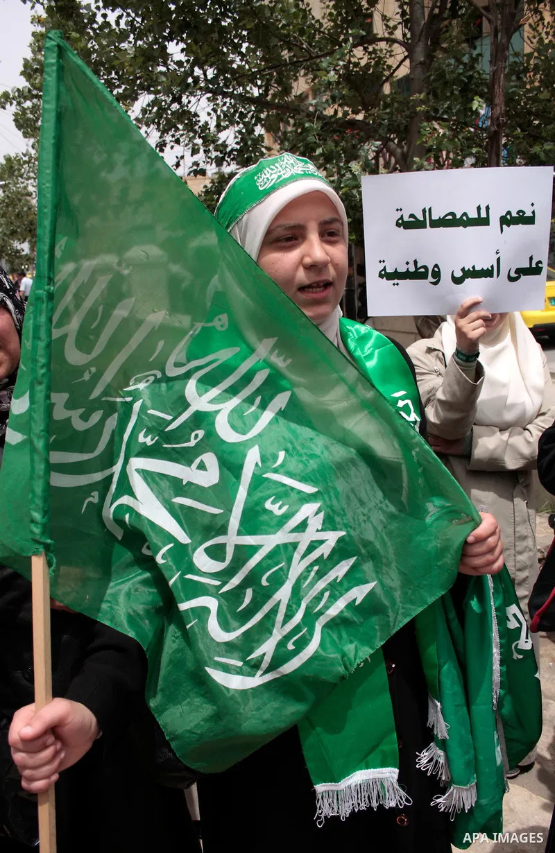 Palestinian women supporters of the Hamas Islamist movement demonstrate in the West Bank city of Hebron on May 04, 2011 as Palestinians in the West Bank and Gaza Strip gather to celebrate and welcome a reconciliation dea...