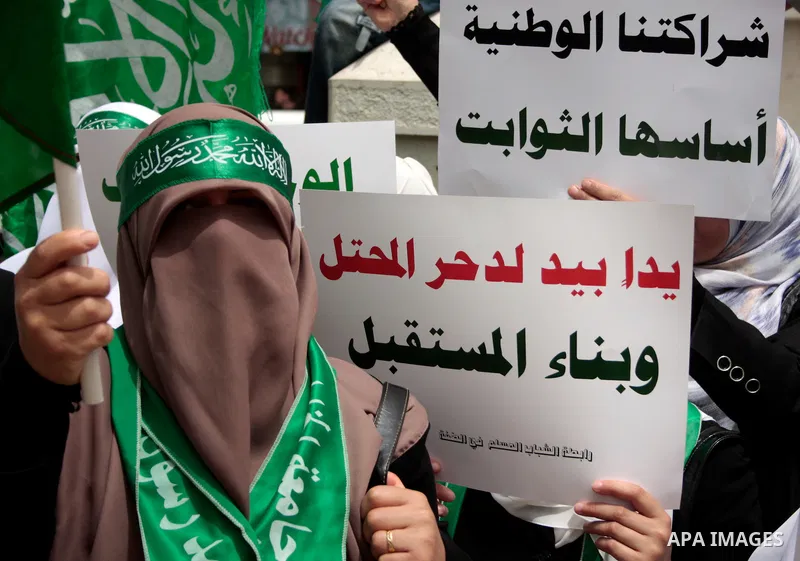 Palestinian women supporters of the Hamas Islamist movement demonstrate in the West Bank city of Hebron on May 04, 2011 as Palestinians in the West Bank and Gaza Strip gather to celebrate and welcome a reconciliation dea...
