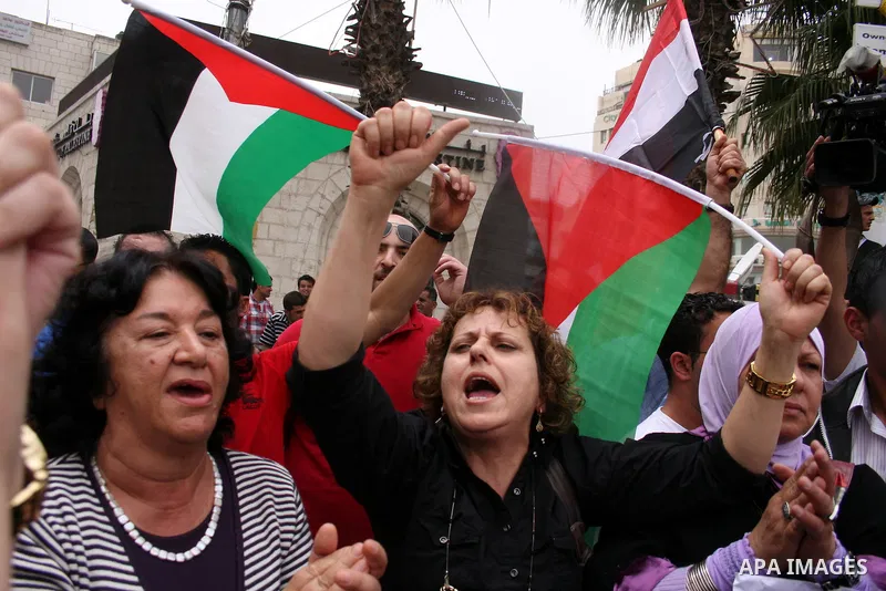 Palestinians celebrate during a rally in the West Bank city of Ramallah on May 04, 2011 as Palestinians in the West Bank and Gaza Strip gather to welcome a reconciliation deal signed by rival movements Hamas and Fatah in...
