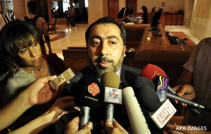 The spokesman of the Palestinian government in Gaza Strip, Taher al-Nono speaks to media at a hotel in Cairo, Egypt on May 4,2011. Fatah and Hamas officials lead a ceremony celebrating the signing of a reconciliation dea...