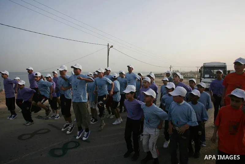Palestinian schoolboys run in Beit Hanun on May 5, 2011 as they compete in the Gaza Strip's first-ever marathon which runs the entire length of the coastal enclave. Photo by Mohammed Othman