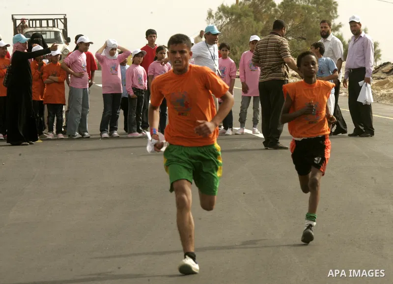 Palestinian and foreign participants run in Rafah town in the southern Gaza Strip on May 5, 2011 as they compete in the Gaza Strip's first-ever marathon which runs the entire length of the coastal enclave. Photo by Abed...