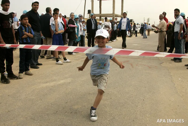 A Palestinian participant runs in Rafah town in the southern Gaza Strip on May 5, 2011 as they compete in the Gaza Strip's first-ever marathon which runs the entire length of the coastal enclave. Photo by Abed Rahim Khat...