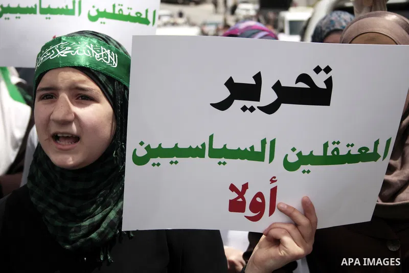 Palestinian Hamas supporters rally in the streets of the West Bank city of Hebron to celebrate on May 6, 2011 the political unity reconciliation deal between the Islamic group and the Fatah movement which was signed by t...