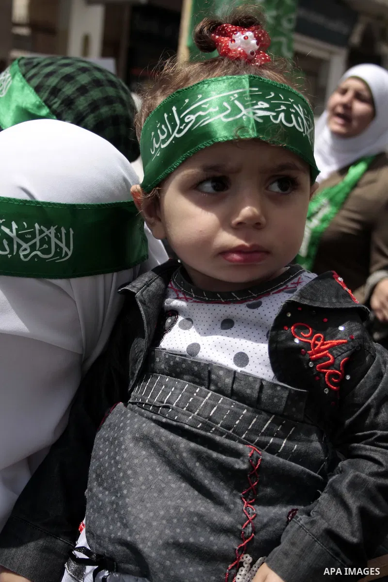 Palestinian Hamas supporters rally in the streets of the West Bank city of Hebron to celebrate on May 6, 2011 the political unity reconciliation deal between the Islamic group and the Fatah movement which was signed by t...