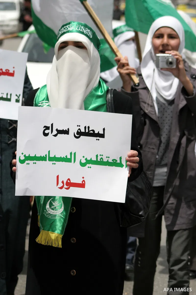 Palestinian Hamas supporters rally in the streets of the West Bank city of Hebron to celebrate on May 6, 2011 the political unity reconciliation deal between the Islamic group and the Fatah movement which was signed by t...