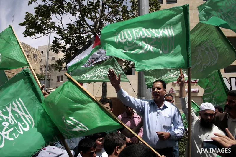 Palestinian Hamas supporters rally in the streets of the West Bank city of Hebron to celebrate on May 6, 2011 the political unity reconciliation deal between the Islamic group and the Fatah movement which was signed by t...
