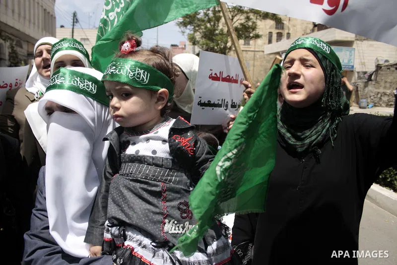 Palestinian Hamas supporters rally in the streets of the West Bank city of Hebron to celebrate on May 6, 2011 the political unity reconciliation deal between the Islamic group and the Fatah movement which was signed by t...