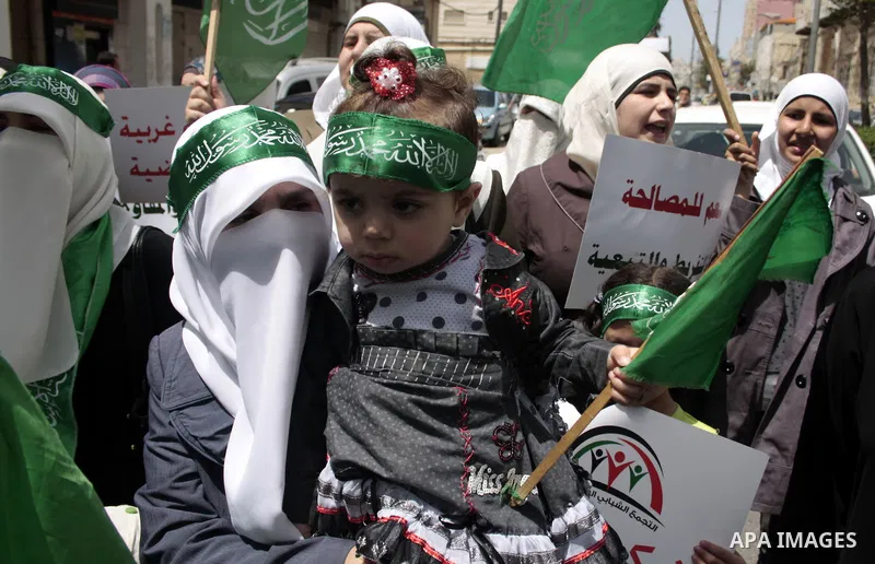 Palestinian Hamas supporters rally in the streets of the West Bank city of Hebron to celebrate on May 6, 2011 the political unity reconciliation deal between the Islamic group and the Fatah movement which was signed by t...