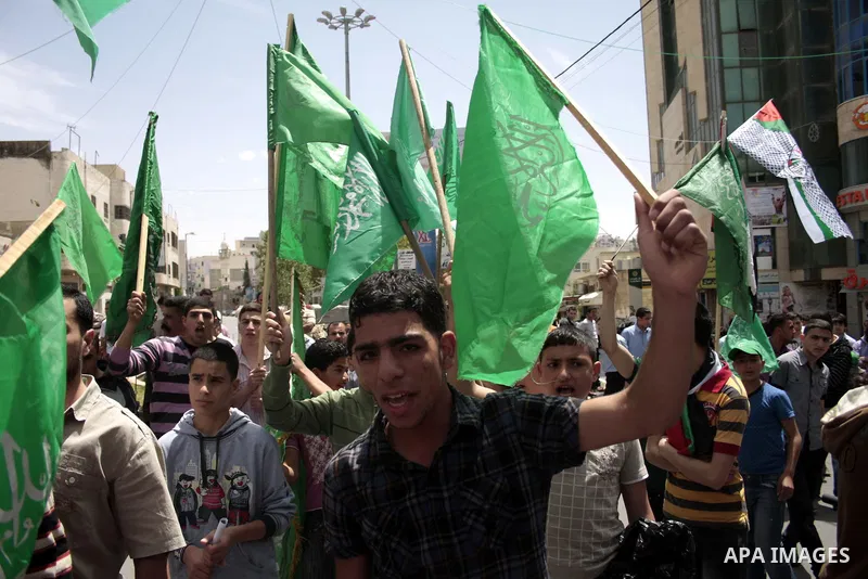 Palestinian Hamas supporters rally in the streets of the West Bank city of Hebron to celebrate on May 6, 2011 the political unity reconciliation deal between the Islamic group and the Fatah movement which was signed by t...