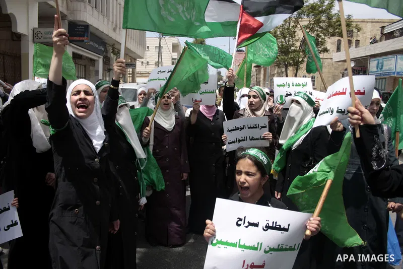 Palestinian Hamas supporters rally in the streets of the West Bank city of Hebron to celebrate on May 6, 2011 the political unity reconciliation deal between the Islamic group and the Fatah movement which was signed by t...