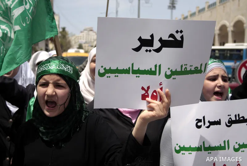 Palestinian Hamas supporters rally in the streets of the West Bank city of Hebron to celebrate on May 6, 2011 the political unity reconciliation deal between the Islamic group and the Fatah movement which was signed by t...