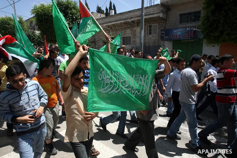 Palestinian Hamas supporters rally in the streets of the West Bank city of Tulkarem to celebrate on May 6, 2011 the political unity reconciliation deal between the Islamic group and the Fatah movement which was signed by...