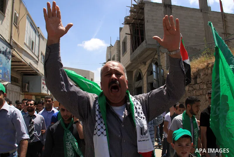 Palestinian Hamas supporters rally in the streets of the West Bank city of Tulkarem to celebrate on May 6, 2011 the political unity reconciliation deal between the Islamic group and the Fatah movement which was signed by...