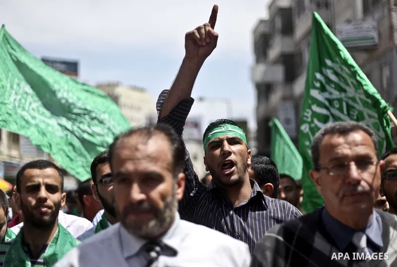 Palestinian Hamas supporters rally in the streets of the West Bank city of Ramallah to celebrate on May 6, 2011 the political unity reconciliation deal between the Islamic group and the Fatah movement which was signed by...