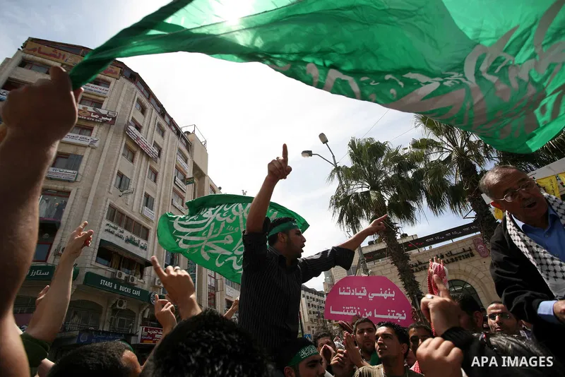 Palestinian Hamas supporters rally in the streets of the West Bank city of Ramallah to celebrate on May 6, 2011 the political unity reconciliation deal between the Islamic group and the Fatah movement which was signed by...