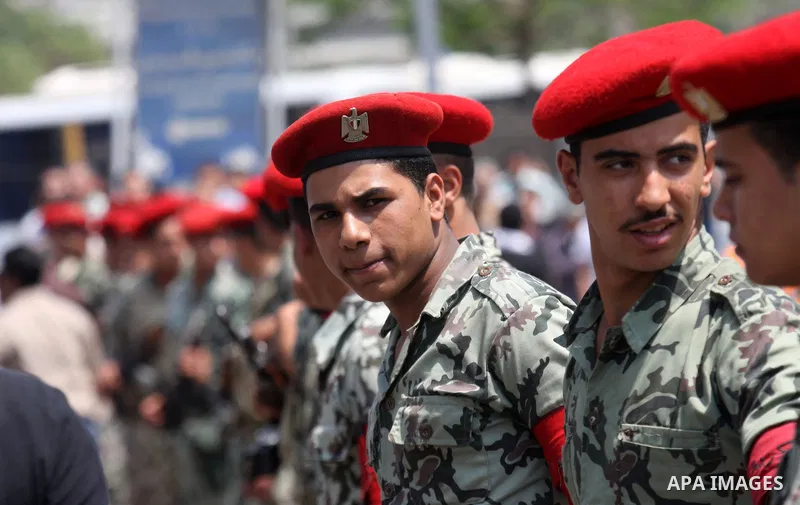 Egyptian forces stand guard as Islamists march to the US embassy after the weekly Friday prayer in Cairo on May 6, 2011, during a demonstration to denounce the killing of Osama bin Laden by US forces in Pakistan. Photo b...