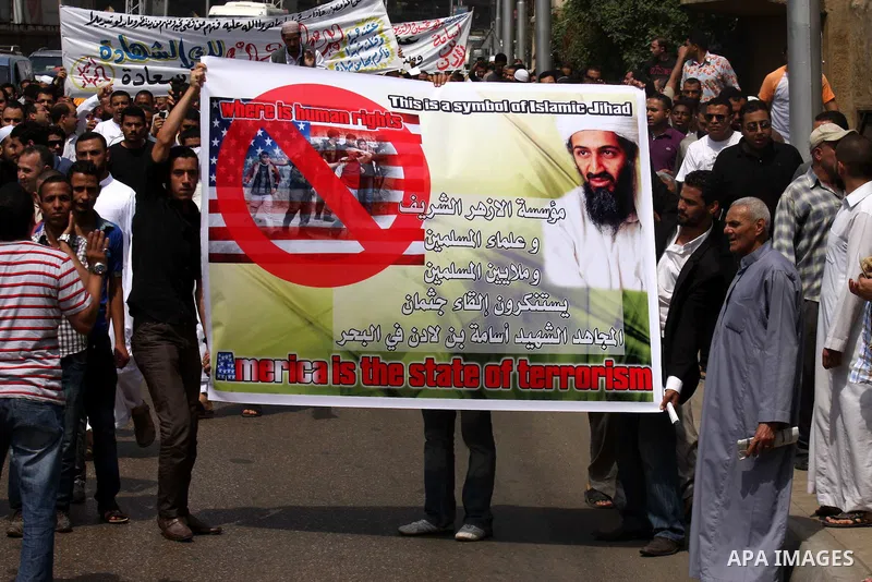 Egyptian Islamists, carrying a picture of late Al-Qaeda chief Osama bin Laden, march to the US embassy after the weekly Friday prayer in Cairo on May 6, 2011, during a demonstration to denounce the killing of Osama bin L...