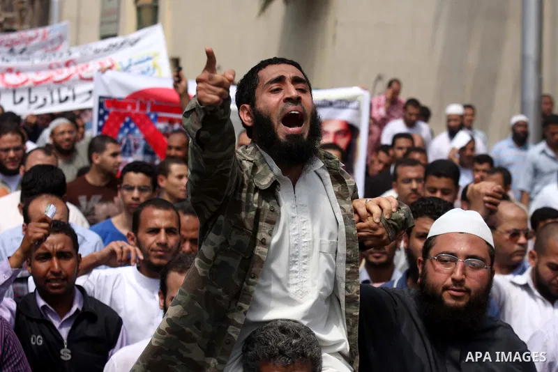 Egyptian Islamists, carrying a picture of late Al-Qaeda chief Osama bin Laden, march to the US embassy after the weekly Friday prayer in Cairo on May 6, 2011, during a demonstration to denounce the killing of Osama bin L...