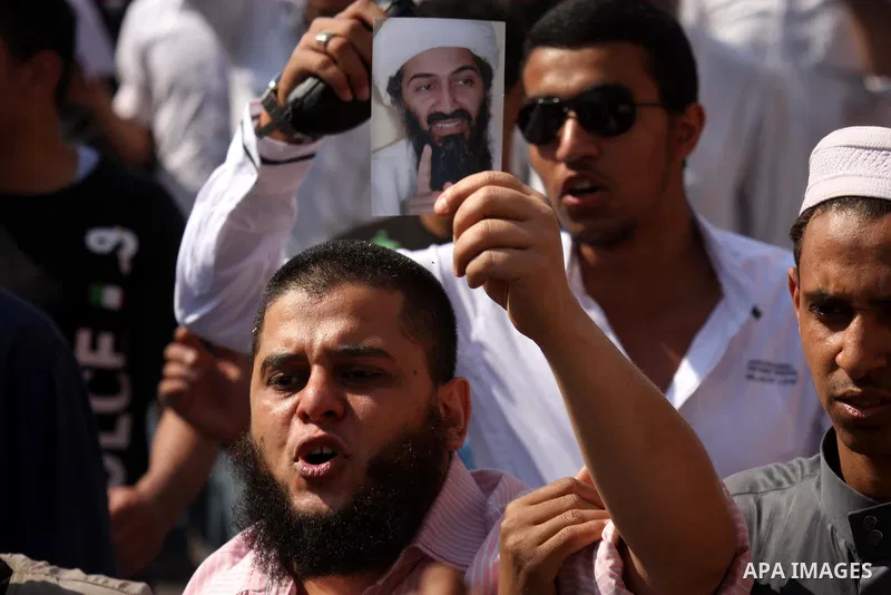 Egyptian Islamists, carrying a picture of late Al-Qaeda chief Osama bin Laden, march to the US embassy after the weekly Friday prayer in Cairo on May 6, 2011, during a demonstration to denounce the killing of Osama bin L...