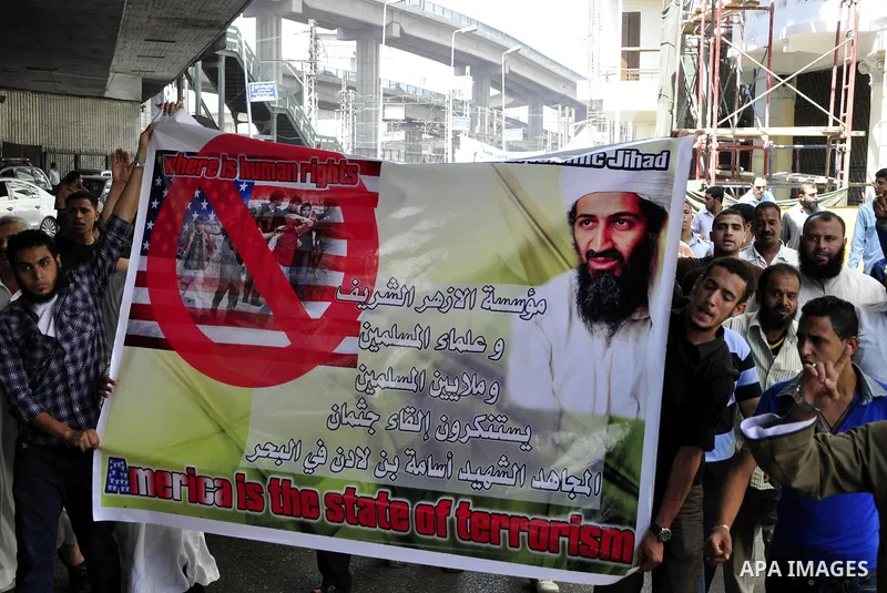 Egyptian Islamist groups hold a picture of Osama bin Laden, during a protest outside the U.S. embassy in Cairo, Egypt, Friday, May 6, 2011. Al-Qaida on Friday confirmed the killing of Osama bin Laden and warned of retali...