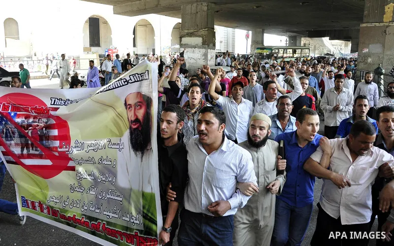 Egyptian Islamist groups hold a picture of Osama bin Laden, during a protest outside the U.S. embassy in Cairo, Egypt, Friday, May 6, 2011. Al-Qaida on Friday confirmed the killing of Osama bin Laden and warned of retali...