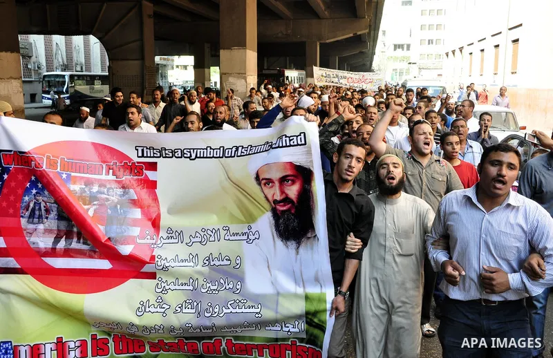 Egyptian Islamist groups hold a picture of Osama bin Laden, during a protest outside the U.S. embassy in Cairo, Egypt, Friday, May 6, 2011. Al-Qaida on Friday confirmed the killing of Osama bin Laden and warned of retali...