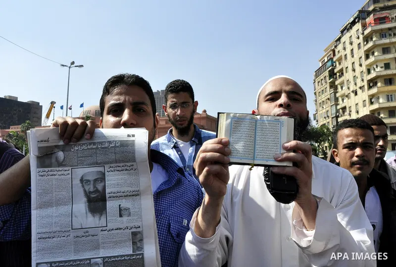 Egyptian Islamist groups hold a picture of Osama bin Laden, during a protest outside the U.S. embassy in Cairo, Egypt, Friday, May 6, 2011. Al-Qaida on Friday confirmed the killing of Osama bin Laden and warned of retali...