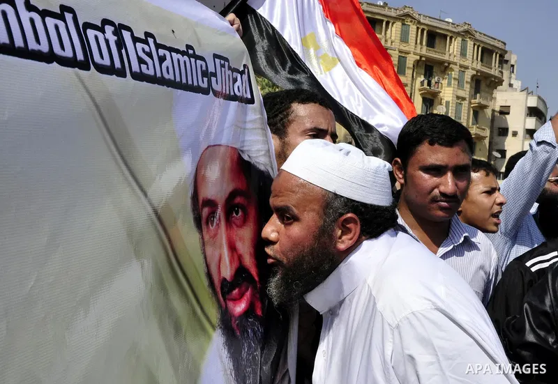 Egyptian Islamist groups hold a picture of Osama bin Laden, during a protest outside the U.S. embassy in Cairo, Egypt, Friday, May 6, 2011. Al-Qaida on Friday confirmed the killing of Osama bin Laden and warned of retali...