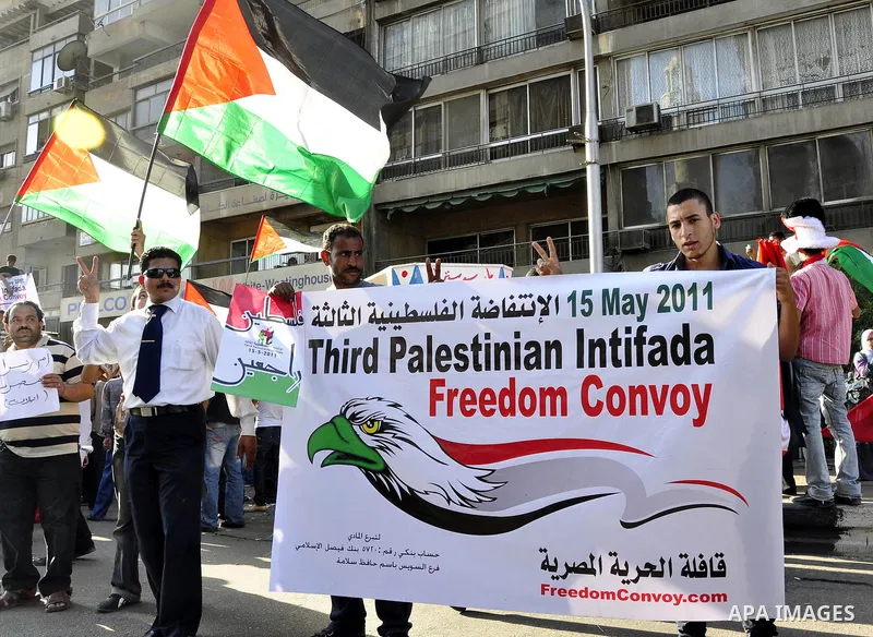 Egyptian protesters wave Palestinian flags and chant slogans outside the Israeli embassy in Cairo, Egypt, Friday, May 6, 2011, in support with Palestinians and against Israeli occupation. Photo by Ahmed Asad