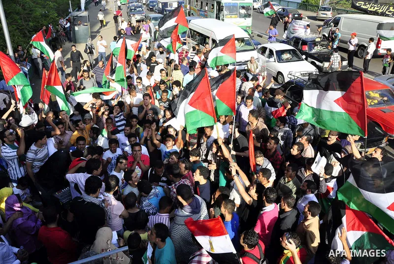 Egyptian protesters wave Palestinian flags and chant slogans outside the Israeli embassy in Cairo, Egypt, Friday, May 6, 2011, in support with Palestinians and against Israeli occupation. Photo by Ahmed Asad