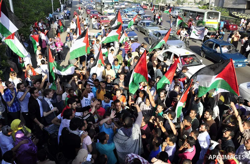 Egyptian protesters wave Palestinian flags and chant slogans outside the Israeli embassy in Cairo, Egypt, Friday, May 6, 2011, in support with Palestinians and against Israeli occupation. Photo by Ahmed Asad
