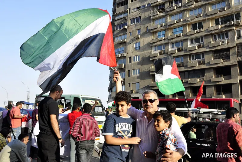 Egyptian protesters wave Palestinian flags and chant slogans outside the Israeli embassy in Cairo, Egypt, Friday, May 6, 2011, in support with Palestinians and against Israeli occupation. Photo by Ahmed Asad