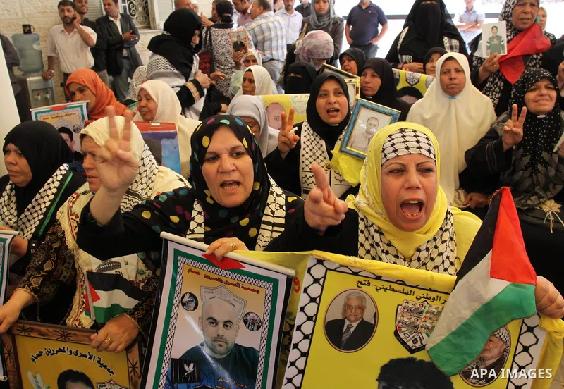 Palestinians hold pictures of jailed relatives during a protest in Gaza city calling for their release from Israeli prisons on Mayl 7, 2011. Photo by Mohamad Asad