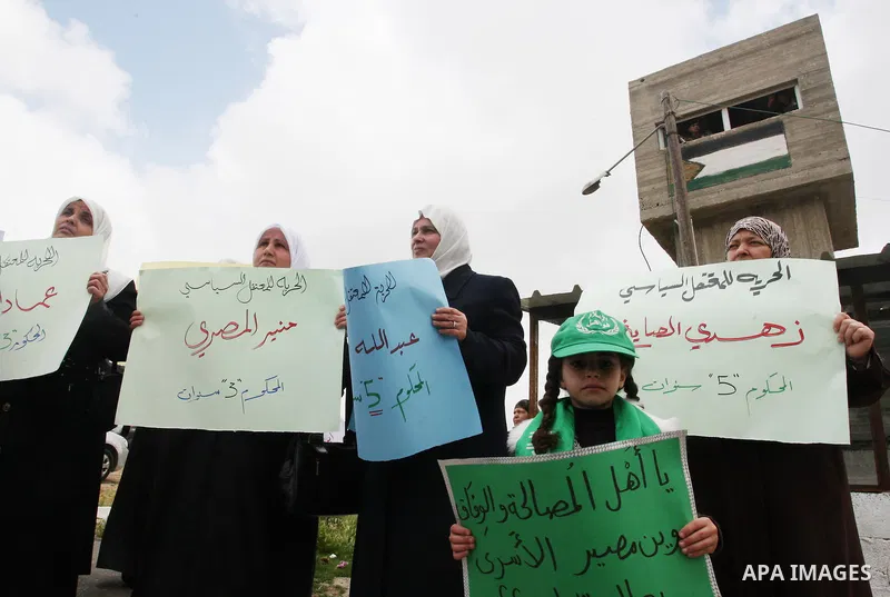 Palestinian women hamas holds a portrait of her relative who is held in jail in Jneid Prison ,during a demonstration in the West Bank city of Nablus for the release of Hamas prisoners from Palestinian jails. Saturday, Ma...