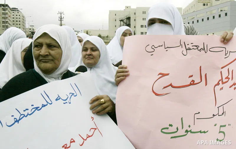 Palestinian women hamas holds a portrait of her relative who is held in jail in Jneid Prison ,during a demonstration in the West Bank city of Nablus for the release of Hamas prisoners from Palestinian jails. Saturday, Ma...